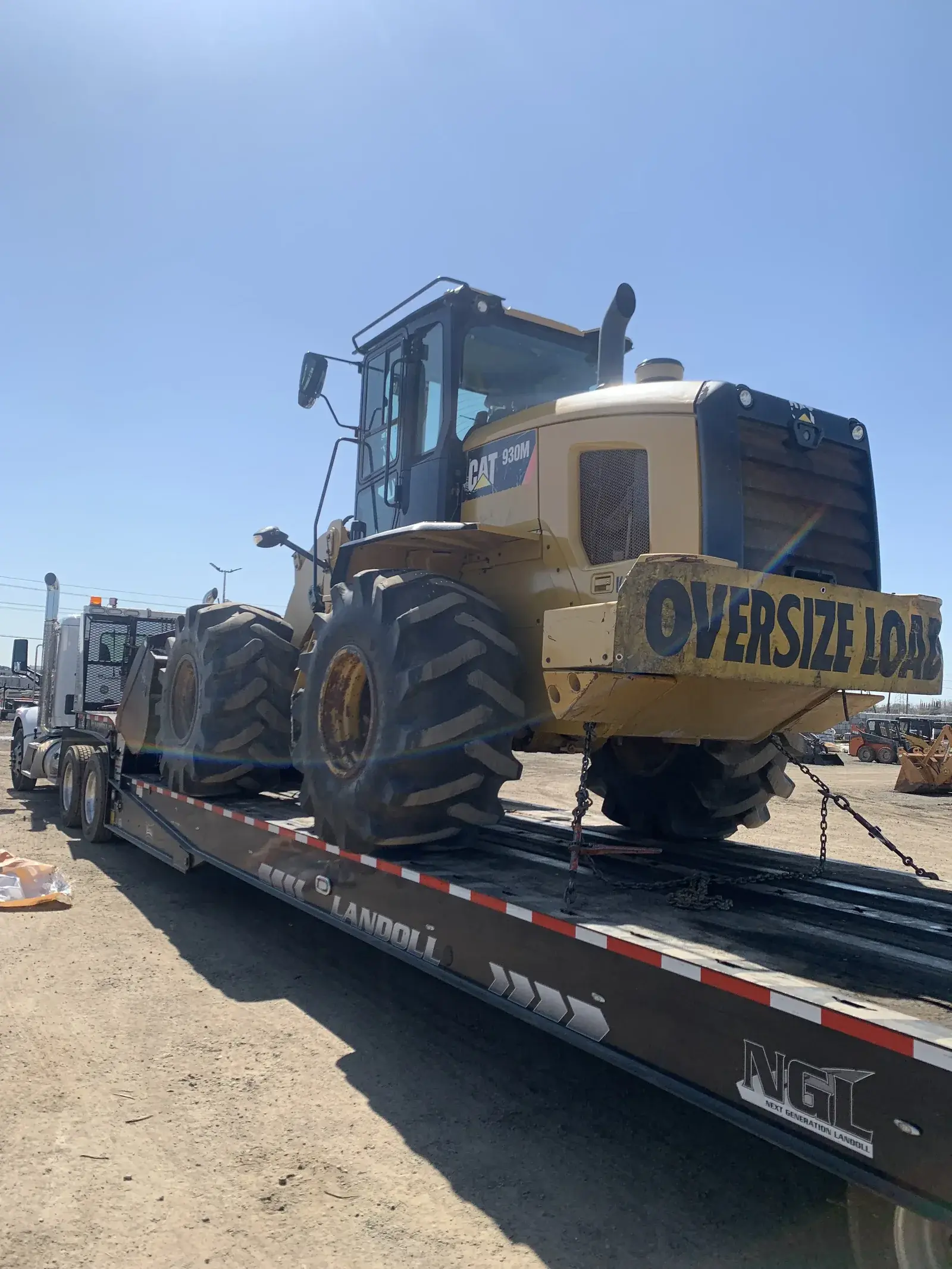 All Star tractor pulling a heavy commercial trailer in transit.