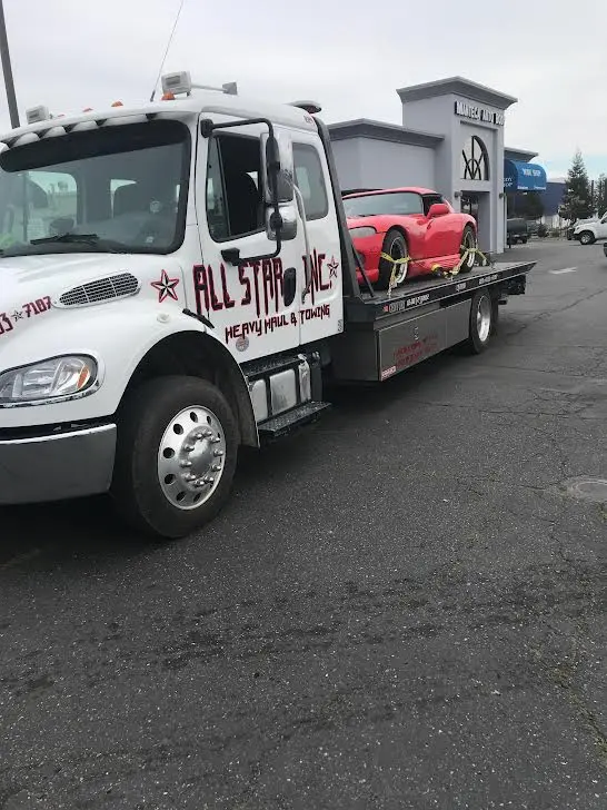 Luxury car being hauled on an All Star transport.