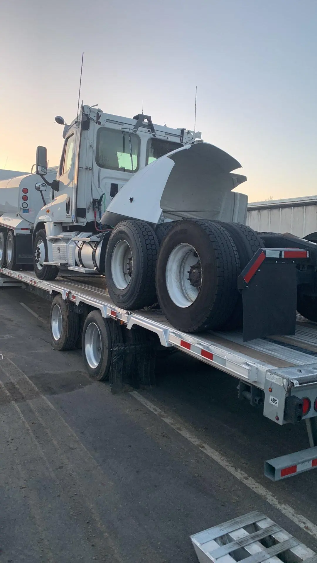 Manteca crew transporting a semi tractor on a Landoll trailer.
